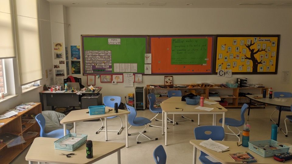 A primary classroom with colourful display boards