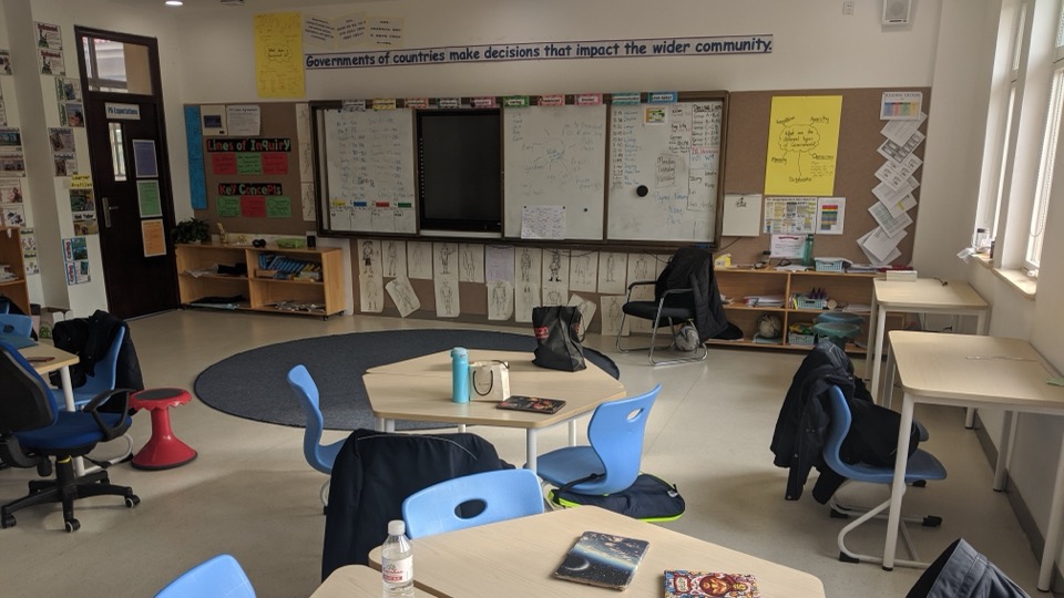 A bright classroom with hexagon tables